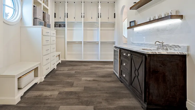 luxury vinyl flooring in room, white shelves, window